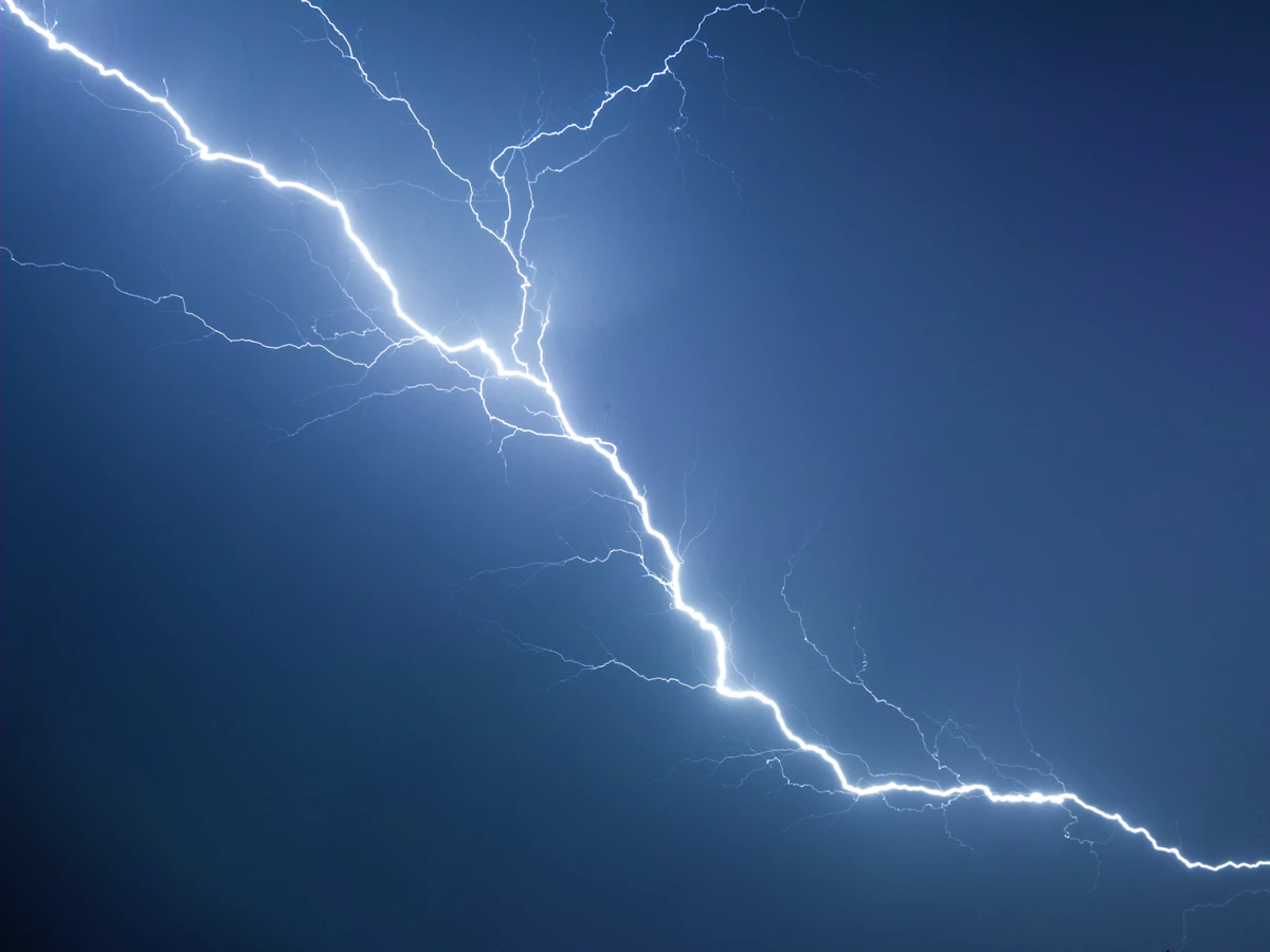 Distant lightning over a dark night sky